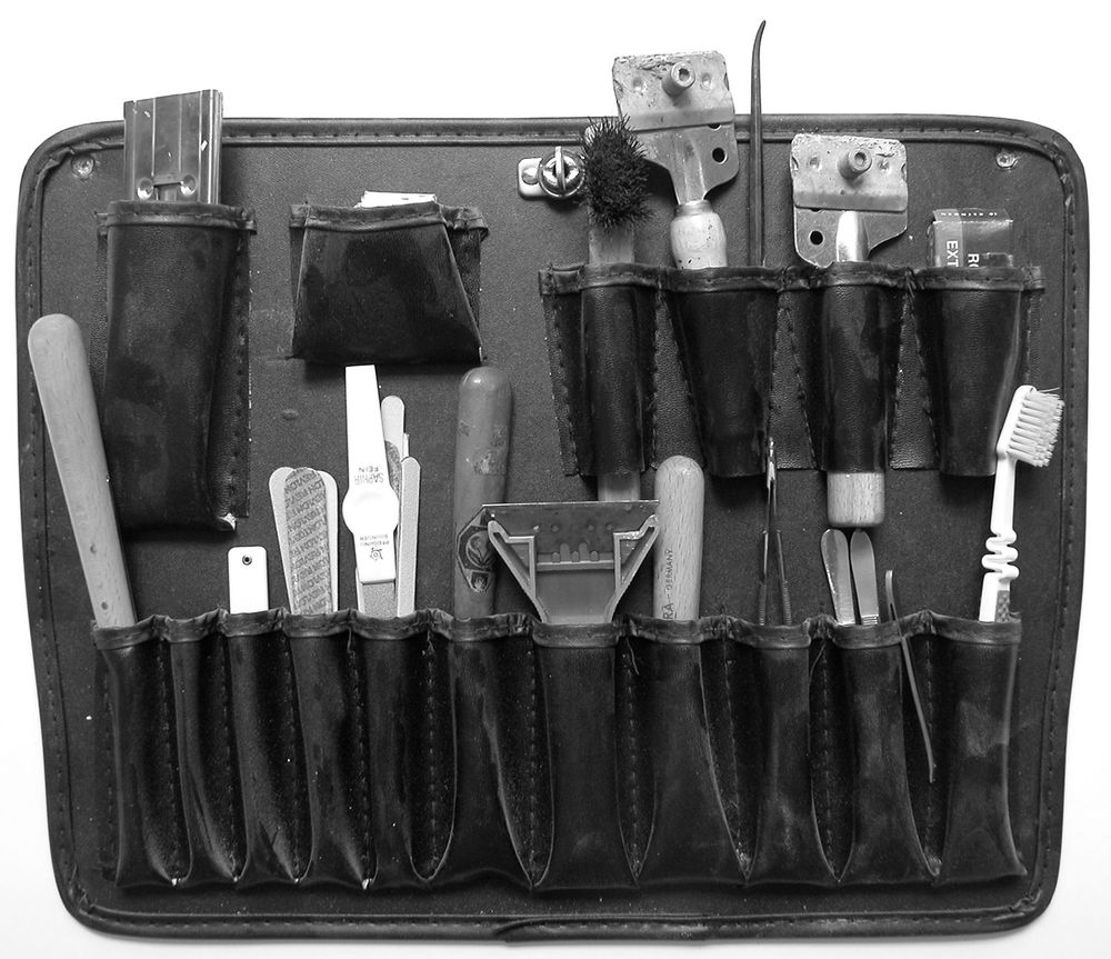 Schwarz-weiß Aufnahme einer Werkzeugtasche, in der sich unterschiedliche Werkzeuge befinden.